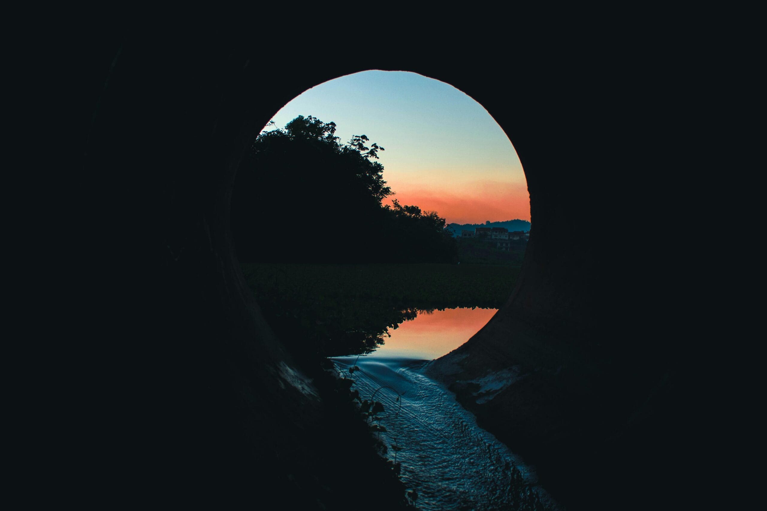 Tunnel leading to water view representing clarity and a hopeful ending.