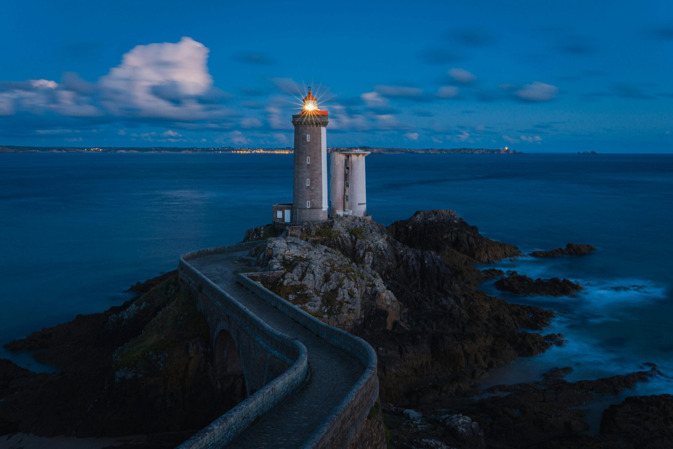 Coastal lighthouse on rocky shore, representing strategic guidance for organizations